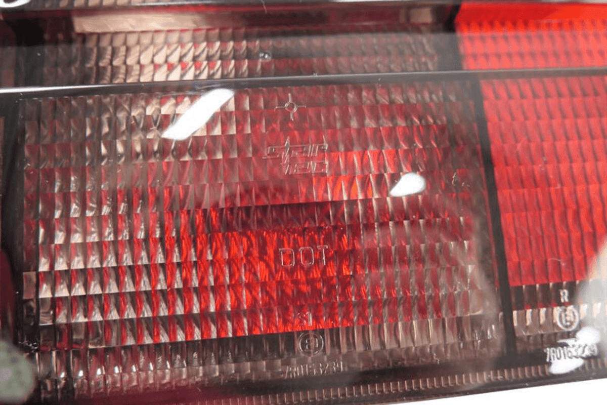 BMW 3 Series E30 original Startec taillights by K2 Industries, 1984-1991, showing red and clear lens tail light assembly.