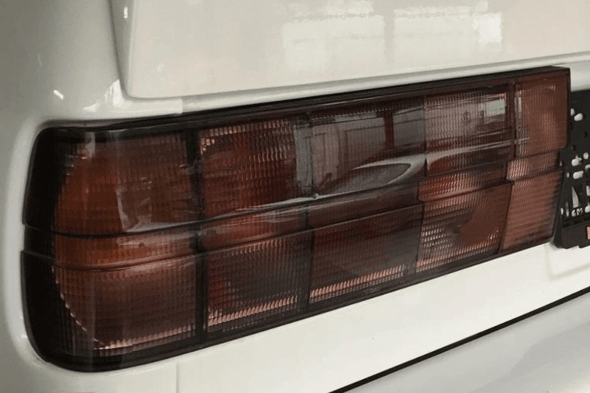 BMW 3 Series E30 original Startec tail lights by K2 Industries, 1984-1991, showing red and clear lens sections for rear illumination.