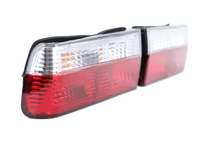 BMW 3-Series E30 pre-facelift tail lights in red and clear, manufactured by K2 Industries, showcasing the classic rear light design.