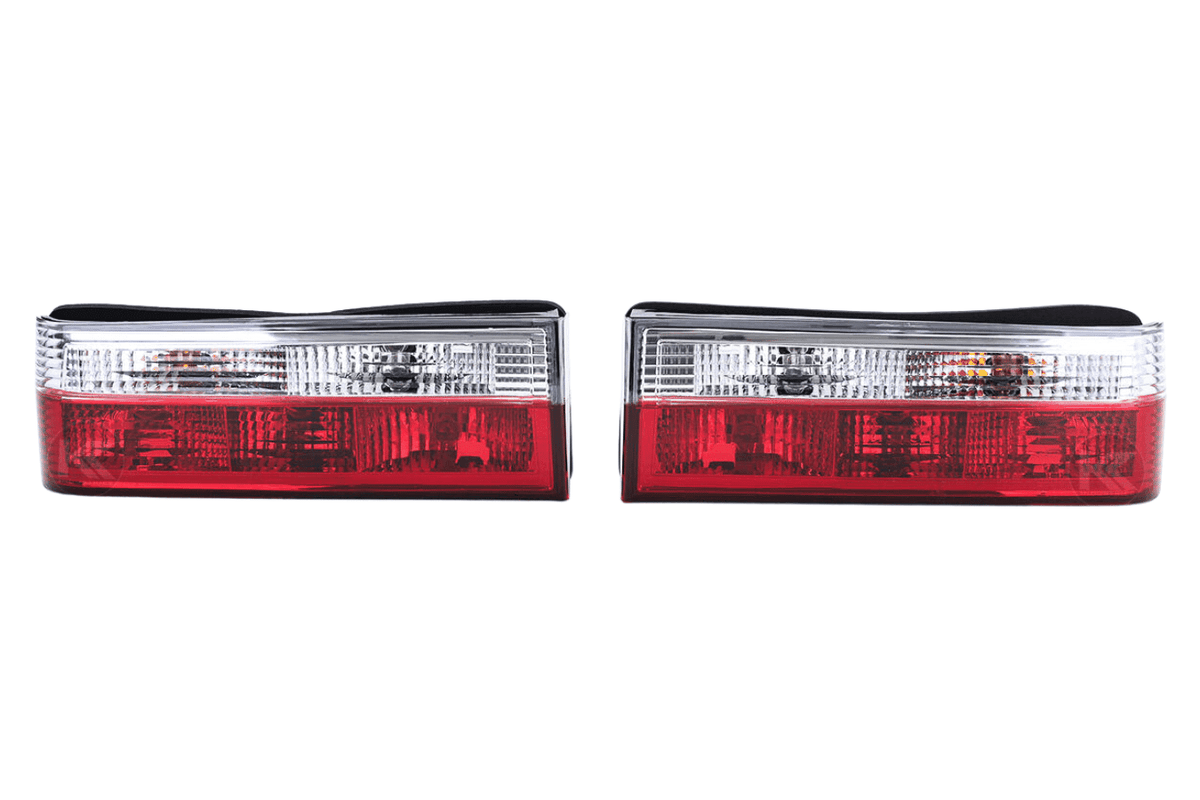 BMW 3-Series E30 pre-facelift tail lights in red and clear, manufactured by K2 Industries, showing the front view of the rear lights.