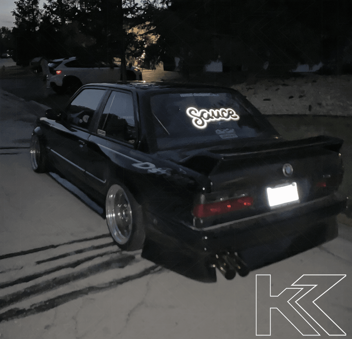 BMW 3-Series E30 pre-facelift red smoked tail lights by K2 Industries, showing close-up of sleek, smoked lens design.