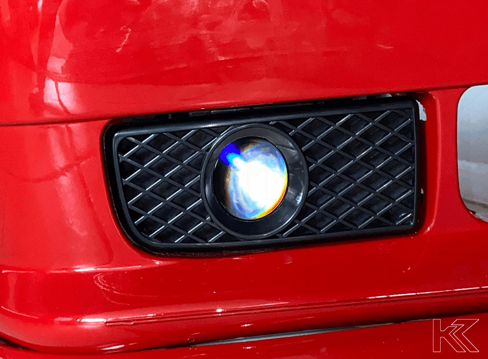 BMW 3-series E36 EVO fog lights by K2 Industries, 1991-2000, showing the clear lens and mounting brackets for classic car upgrade.