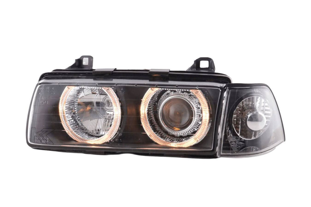 BMW 3 Series E36 sedan black angel eyes LED headlights by K2 Industries, showing the front view with illuminated angel eyes.