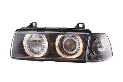 BMW 3 Series E36 sedan black angel eyes LED headlights by K2 Industries, showing the front view with illuminated angel eyes.