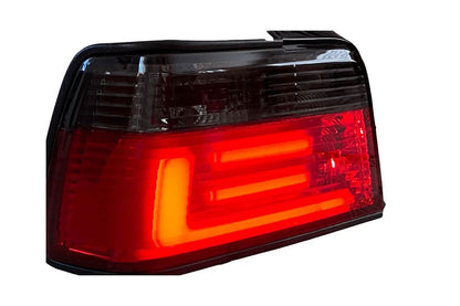 BMW 3 Series E36 sedan JDM red and smoke LED bar tail lights by K2 Industries, showing close-up of rear lighting design.