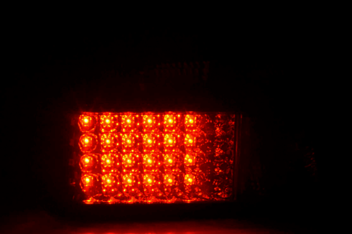 BMW 3-series E36 sedan smoked LED taillights set by K2 Industries, featuring black-tinted lens and modern LED design.