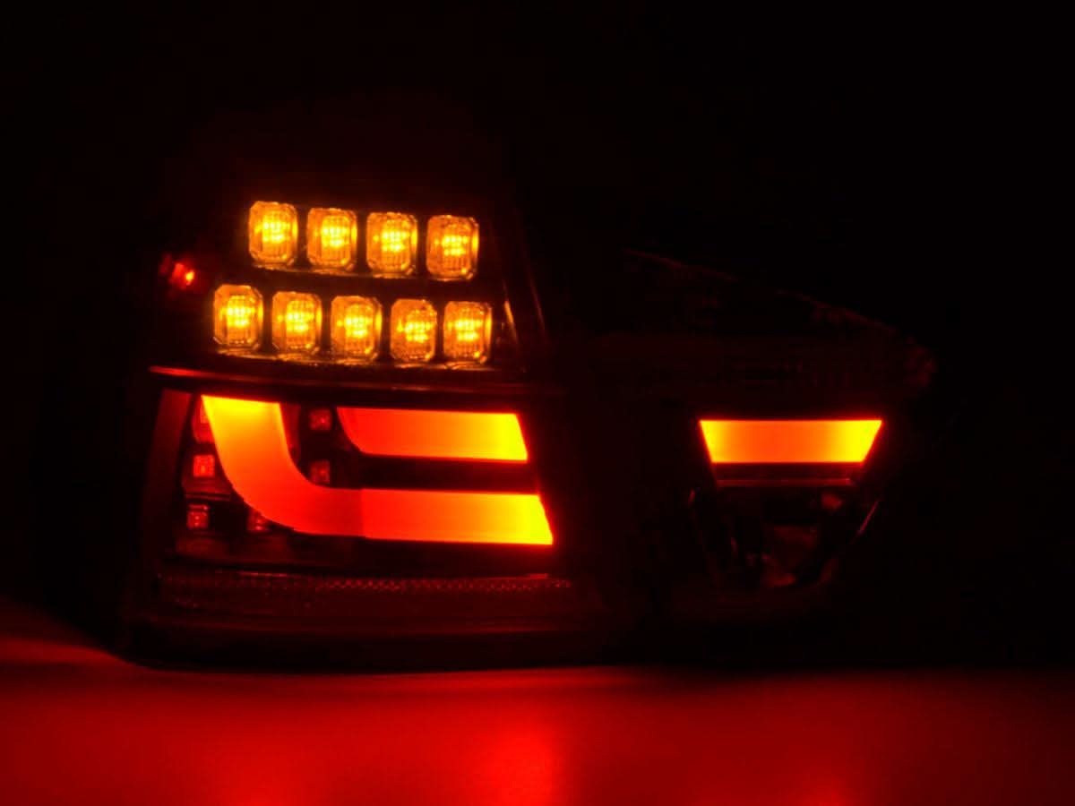 BMW 3-Series E90 sedan red and black LED tail lights by K2 Industries, compatible with 2005-2008 models, showing close-up of taillight design.