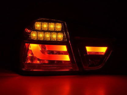 BMW 3-Series E90 sedan tail lights with red smoked LED bar, aftermarket taillights by K2 Industries for 2005-2008 models.