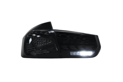 BMW 3 Series F30 F35 F80 black dragon scale LED tail lights by K2 Industries installed on a 2012-2019 model.