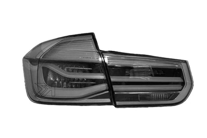 BMW 3-Series F30/F80 clear tail lights installed on a 2011-2020 vehicle, showcasing sleek, modern design by K2 Industries.