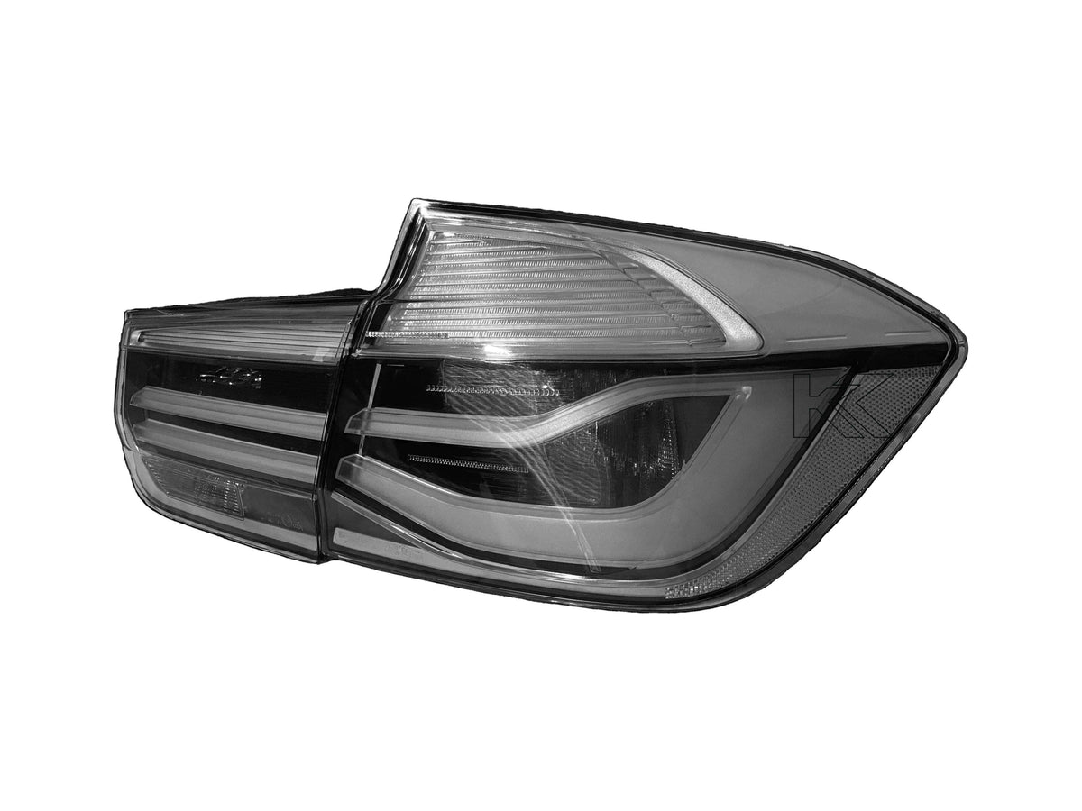 BMW 3-Series F30/F80 clear tail lights installed on a car, showcasing sleek, modern design for models 2011 to 2020 by K2 Industries.