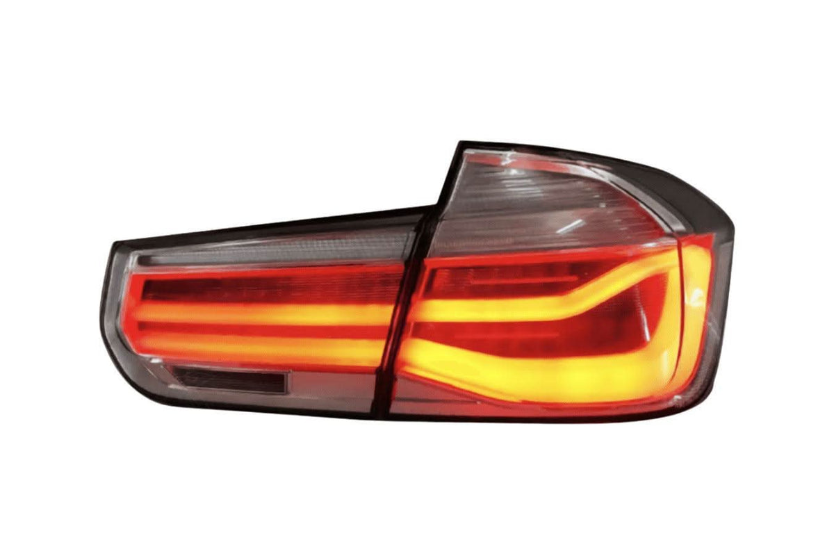 BMW 3-Series F30/F80 clear tail lights installed on a 2011-2020 model, showcasing sleek, modern design by K2 Industries.