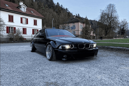 BMW 5-Series E39 sedan full over fender kit by K2 Industries, showcasing black over fenders on the car's wheel arches.