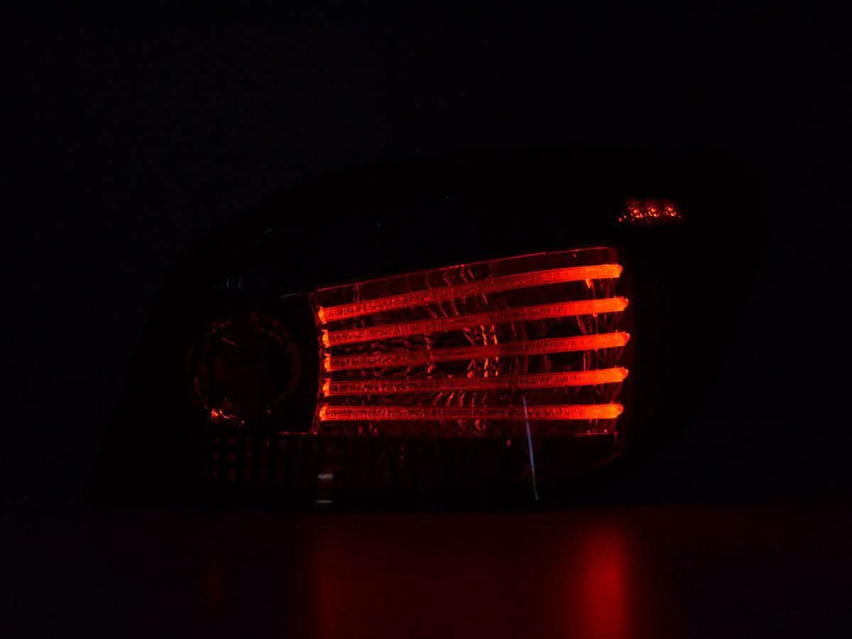 BMW 5-series E60 Sedan red smoked LED tail lights set by K2 Industries, designed for 2008-2009 models, showing the car’s rear with smoked lenses.