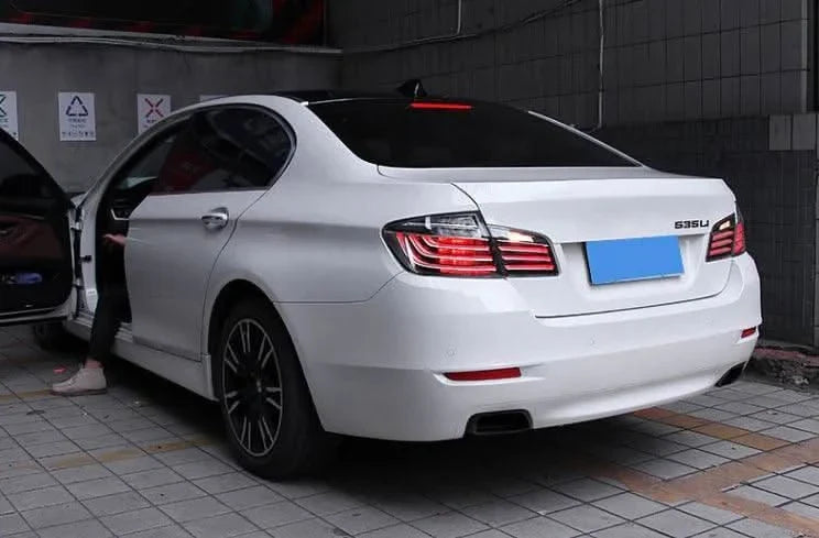 BMW 5-Series F10 clear style LED tail lights by K2 Industries, installed on the rear of a 2010-2017 model.