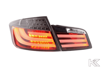 BMW 5-Series F10 sedan black LED taillights, 2010-2012, by K2 Industries, showing close-up of sleek rear tail light design.