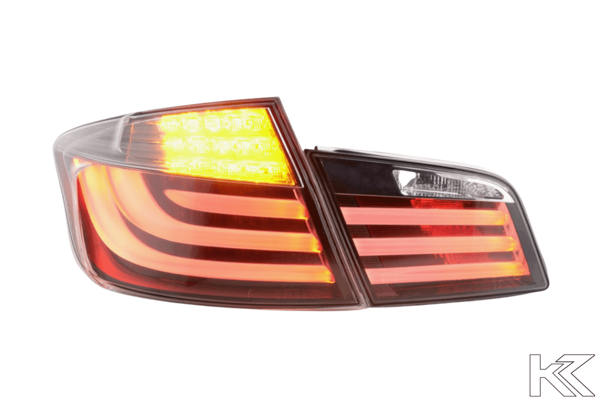 BMW 5-Series F10 sedan black LED tail lights by K2 Industries, showing close-up of sleek rear lighting design for 2010-2012 models.