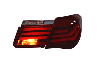 BMW 7-Series F02 red tail lights by K2 Industries, installed on the 2009-2015 model with clear lens and LED design.
