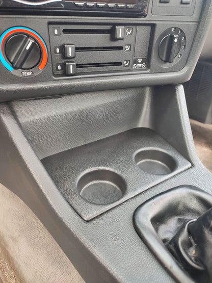 BMW E30 interior cup holder V2 by K2 Industries, modern black design, fits seamlessly in vehicle interior for convenient drink storage.