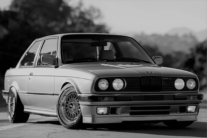 BMW E30 Series 3 IS Style front lip by K2 Industries, black aerodynamic front lip for 1984-1991 E30 models, enhances sporty appearance.