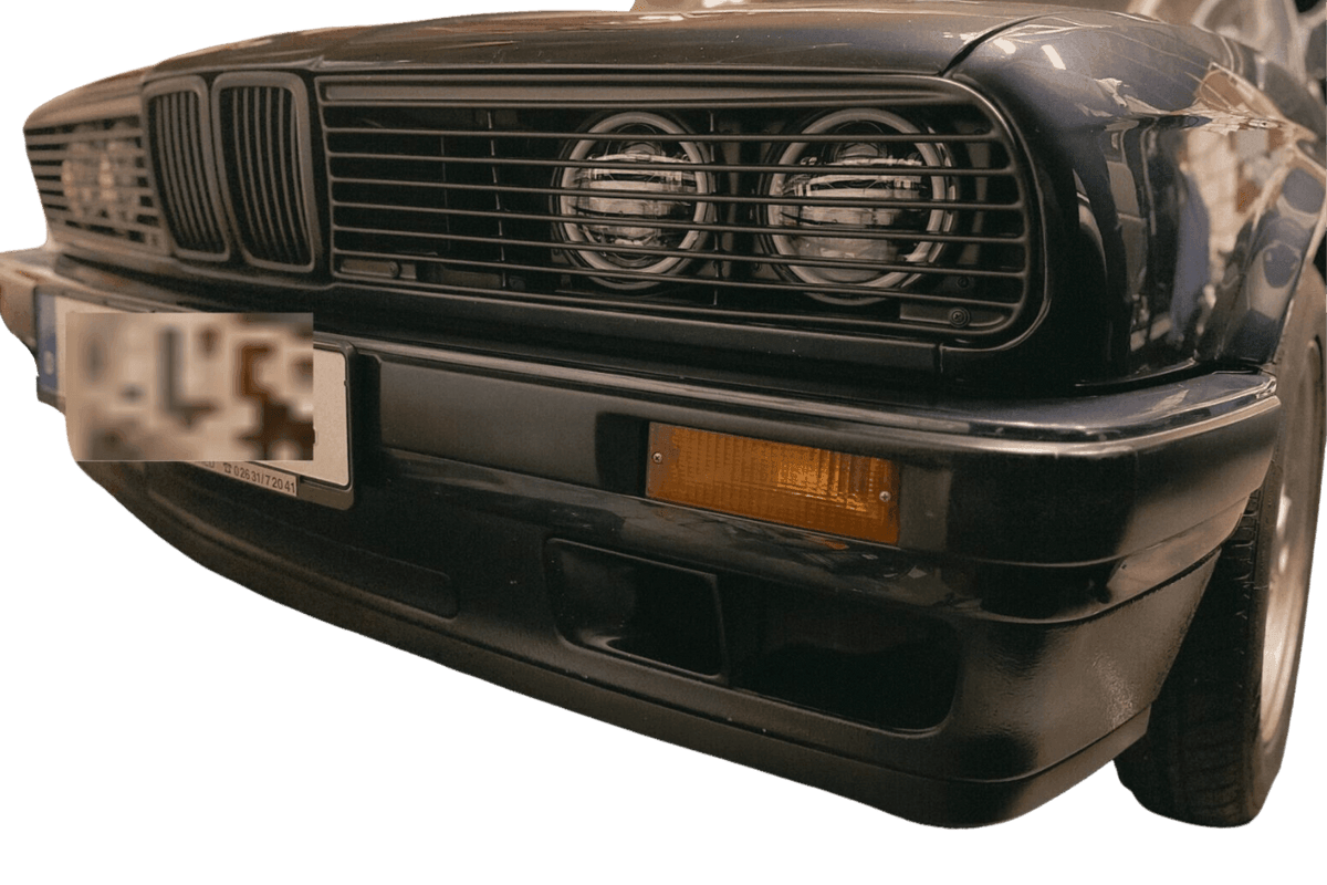 BMW E30 Series 3 headlights and front grille by K2 Industries, showing the sleek design of the 1984-1991 model.