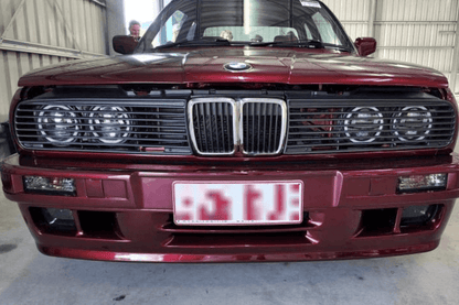 BMW E30 Series 3 headlights and front grille by K2 Industries, classic design for 1984-1991 E30 models, close-up view.