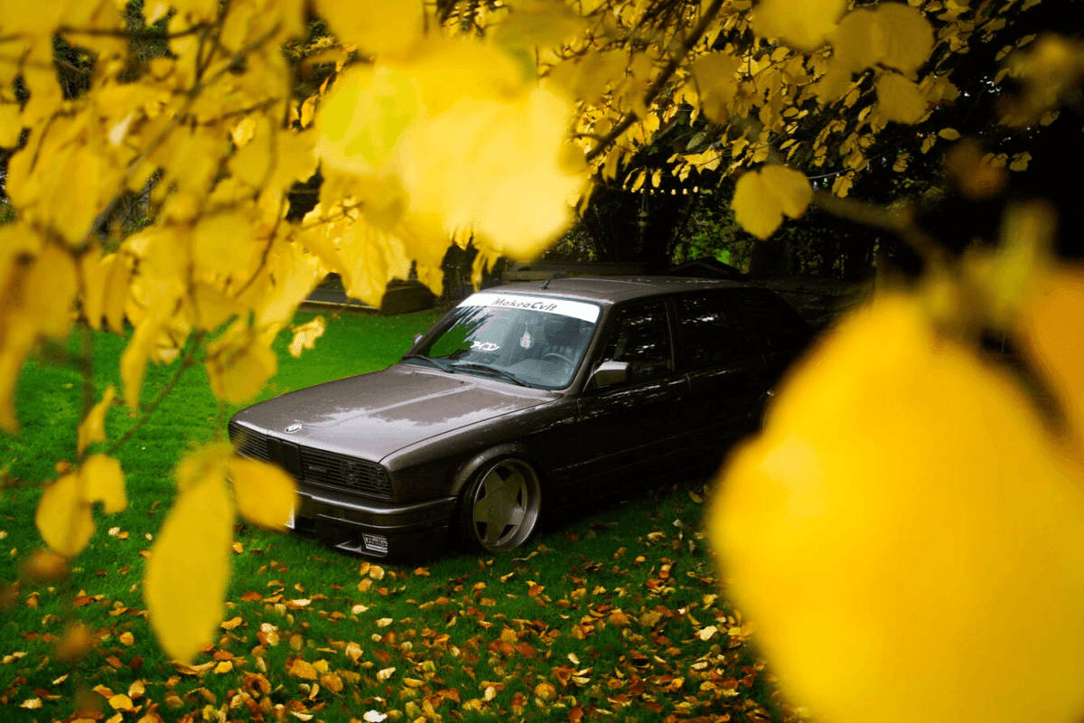 BMW E30 Series 3 headlights and front grille by K2 Industries, featuring clear headlight lenses and sleek grille design.