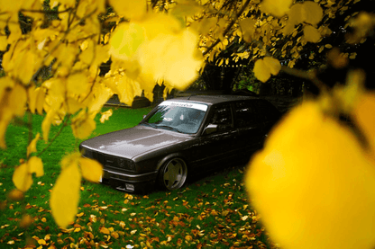 BMW E30 Series 3 headlights and front grille by K2 Industries, featuring clear headlight lenses and sleek grille design.