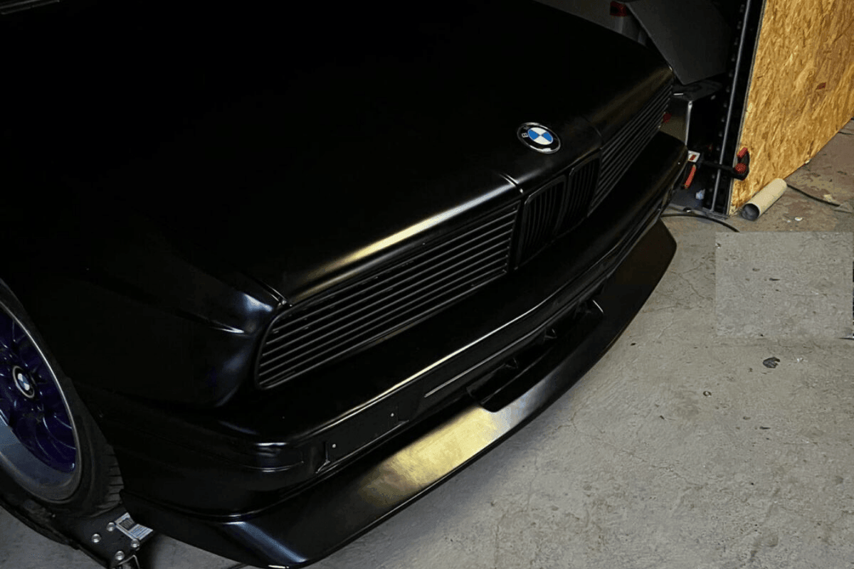 BMW E30 Series 3 front grille and headlights by K2 Industries, featuring sleek design for 1984-1991 model years.