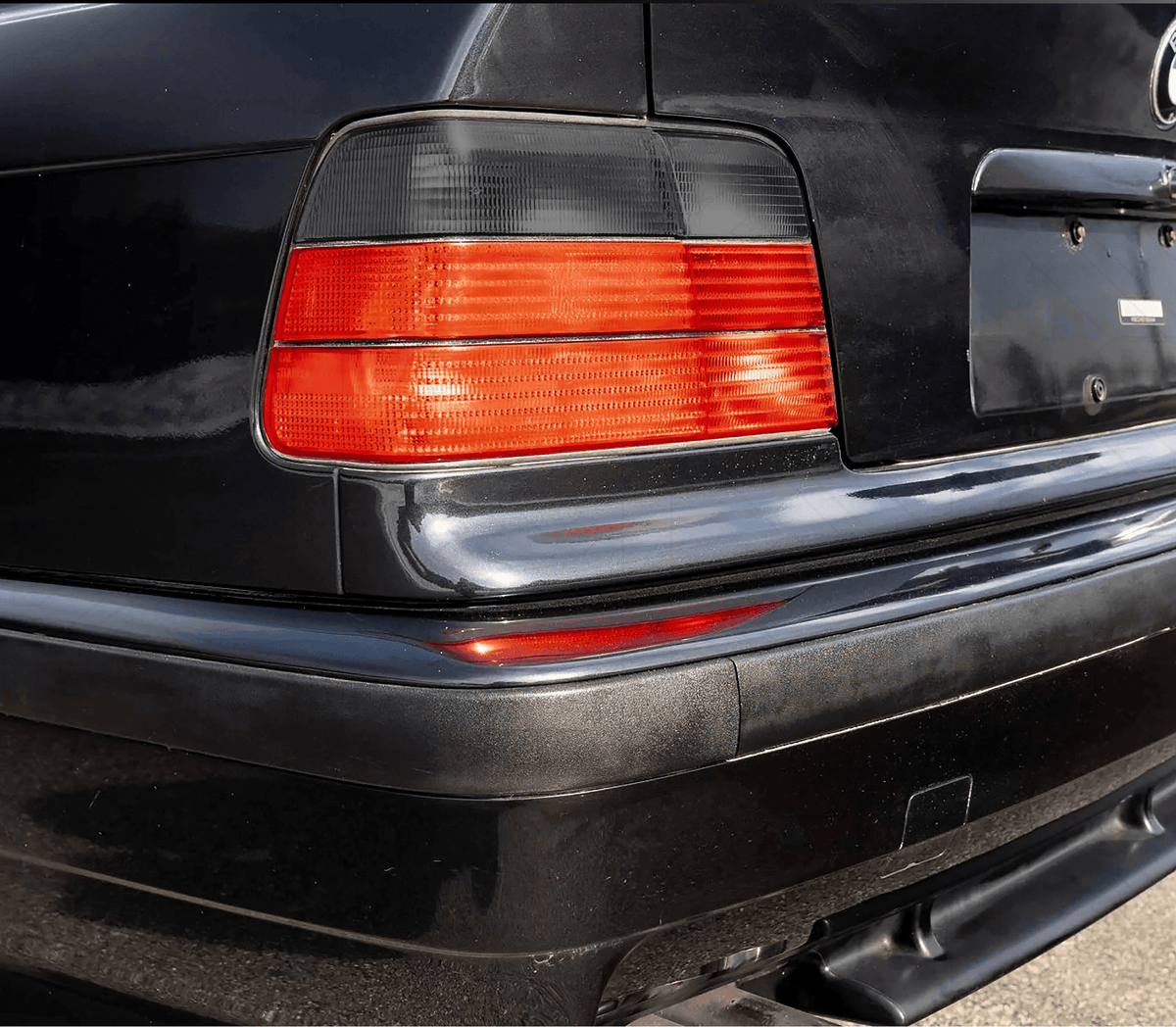 BMW E36 4-door tail lights by K2 Industries for 1992-1999, showing clear lens and red and amber sections for rear lighting.