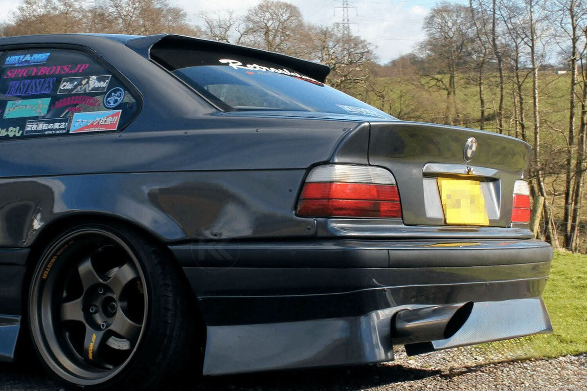 Black BMW E36 Coupe Series 3 HM roof spoiler by K2 Industries, mounted on the car's rear roof for sporty style.