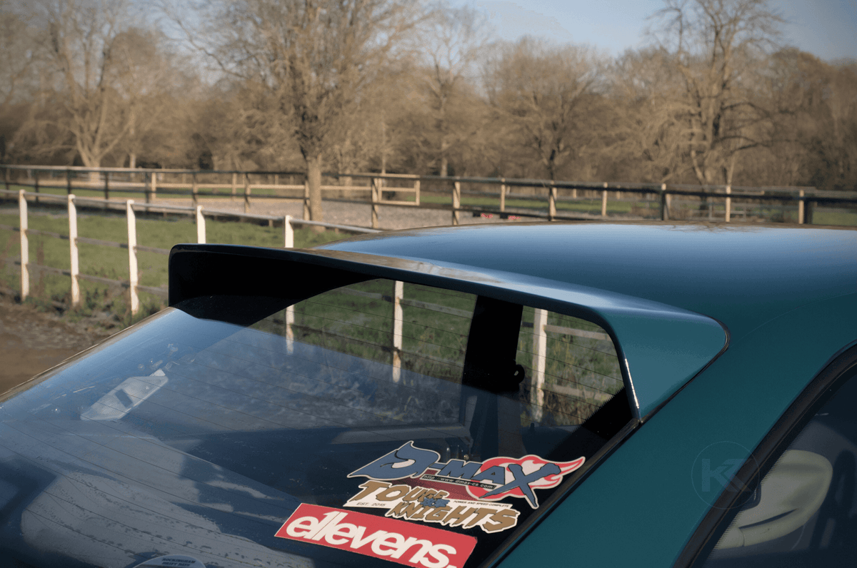 Black BMW E36 Coupe Series 3 HM Roof Spoiler V2 by K2 Industries on a 1990-2000 model, showcasing the sleek roof wing design.