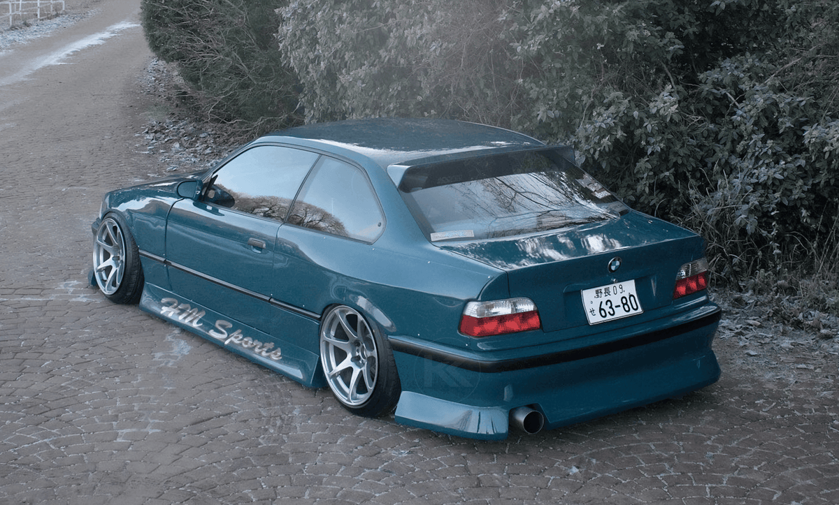 Black BMW E36 Coupe Series 3 HM roof spoiler V2 by K2 Industries, mounted on the car's rear roof area.