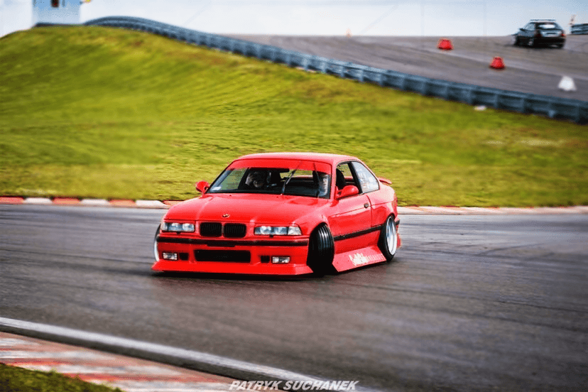 BMW E36 JDM Style Front Lip V2 by K2 Industries installed on a 1992-1999 BMW E36 vehicle, showcasing the sleek front lip design.