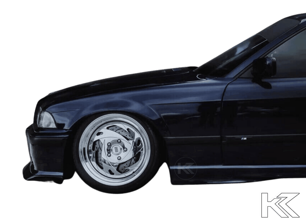 BMW E36 M3 Series 3 JDM Style front lip in black from K2 Industries, designed for 1992-1999 models, shown on the car's front bumper.