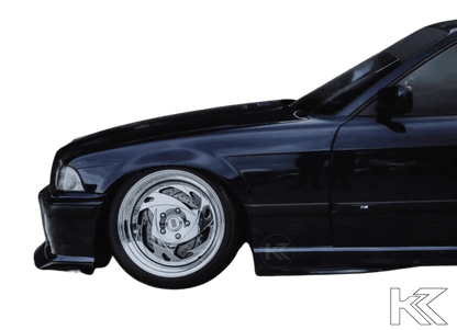 BMW E36 M3 Series 3 JDM Style front lip in black from K2 Industries, designed for 1992-1999 models, shown on the car's front bumper.