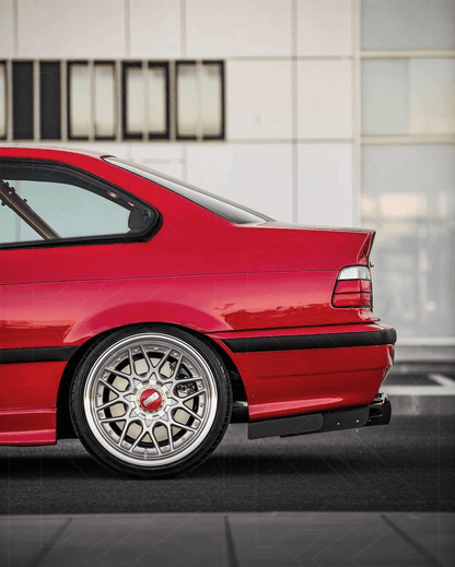 BMW E36 Precision Aluminum Diffuser V1 by K2 Industries installed on the rear of the vehicle, showcasing its sleek metallic design.