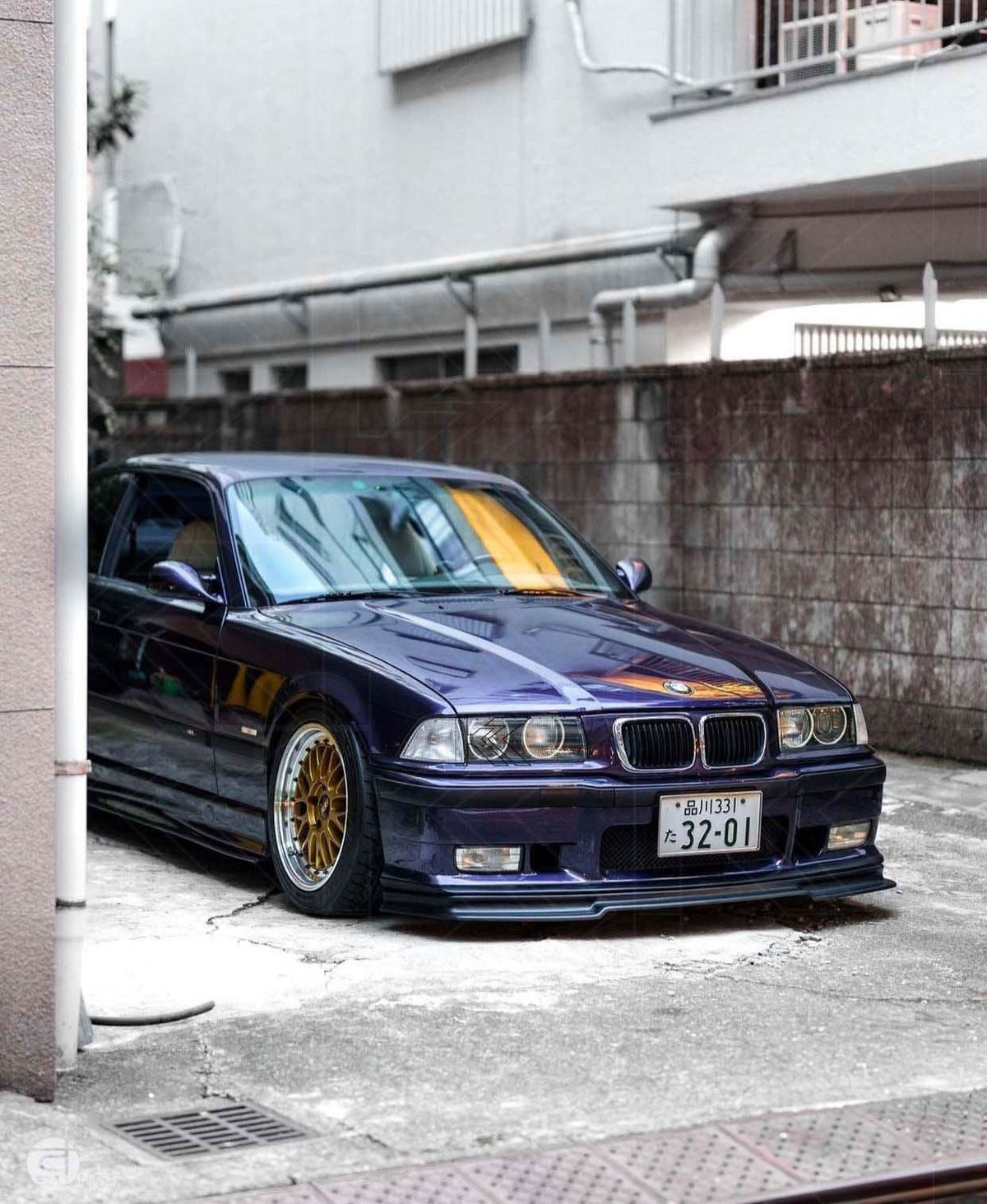 BMW E36 Rieger front lip for M3, designed for 1990-1999 models, by K2 Industries, shown on a black car.