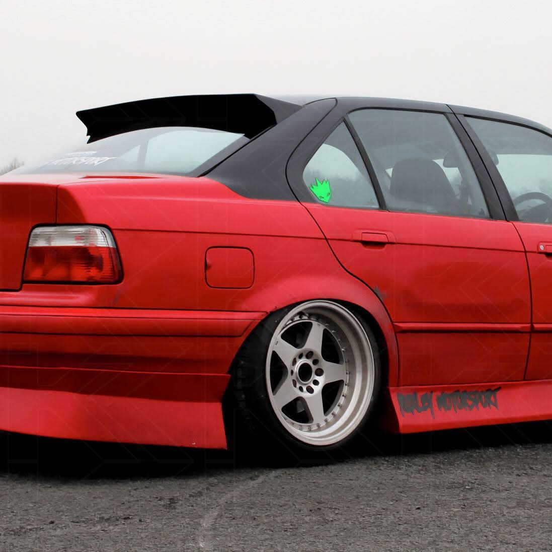 Black BMW E36 Sedan Series 3 HM Style roof spoiler by K2 Industries, mounted on the roof of a 1990-2000 model.