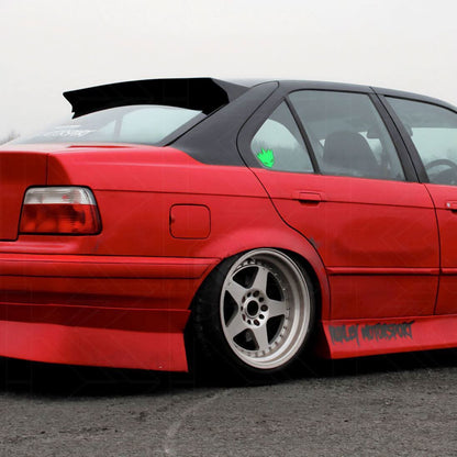 Black BMW E36 Sedan Series 3 HM Style roof spoiler by K2 Industries, mounted on the roof of a 1990-2000 model.