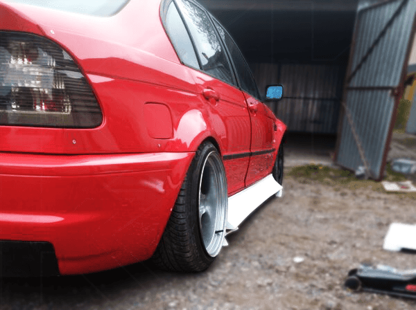 BMW E36 Series 3 JDM style side skirt by K2 Industries, black, sleek design, installed on a 1992-1999 coupe model.