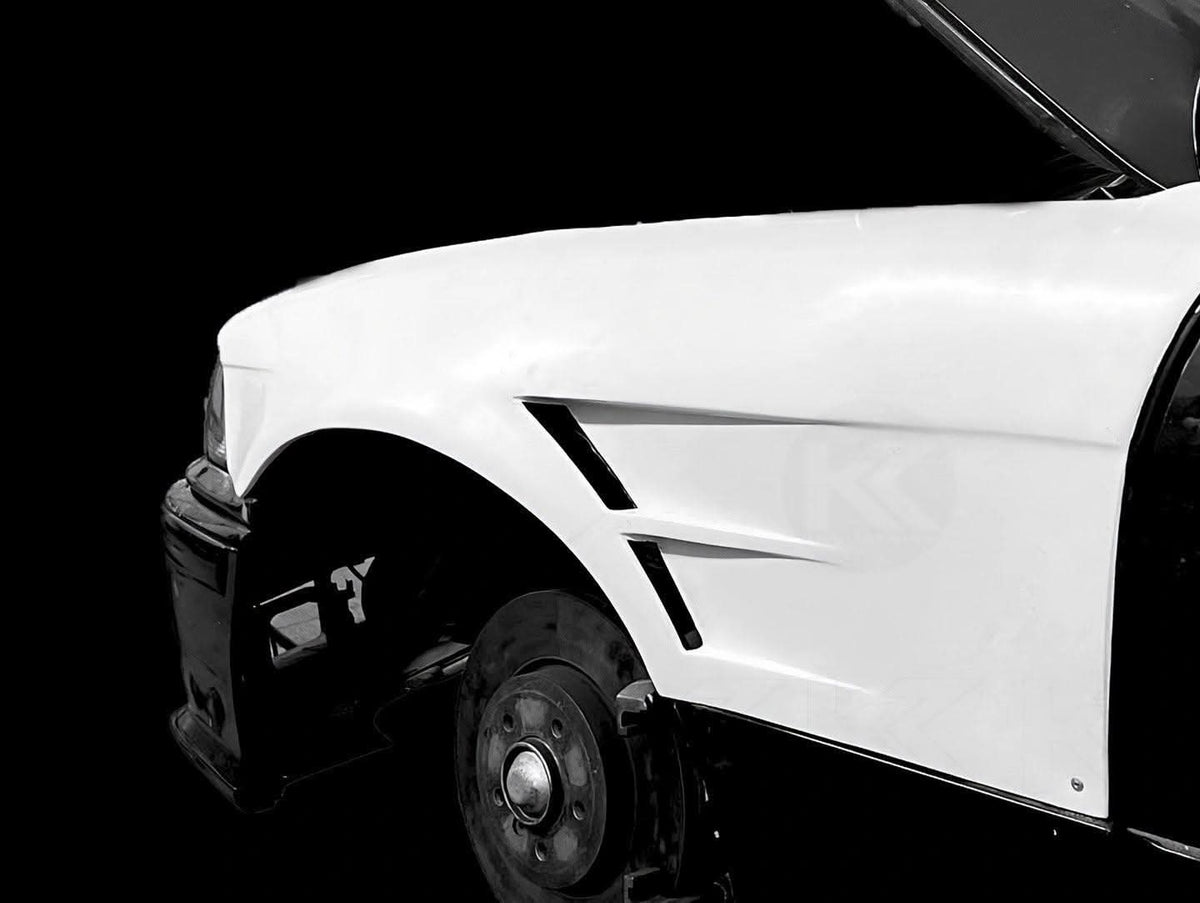 BMW E36 Vented Front Over-Fenders by K2 Industries, showcasing durable metal construction and vented design for sporty style.