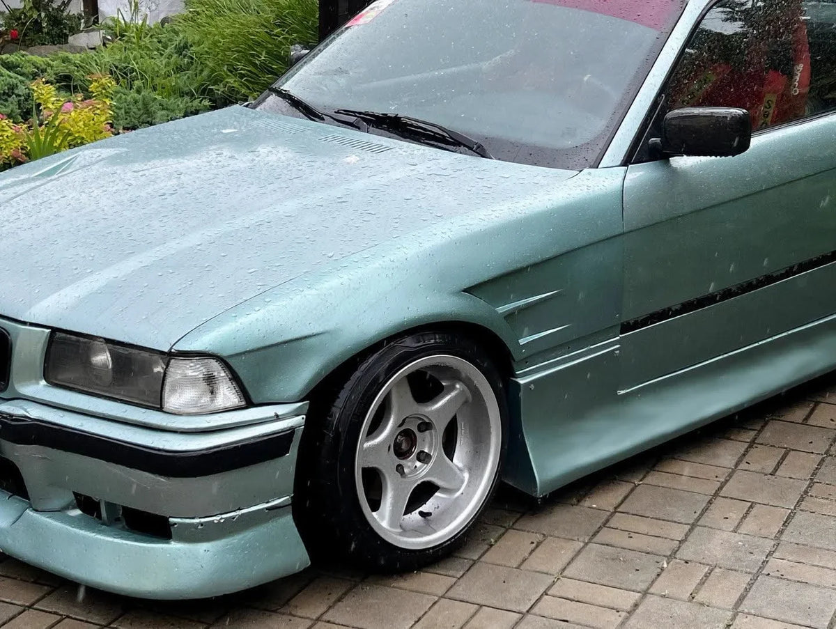 BMW E36 Vented Front Over-Fenders by K2 Industries, showcasing black, vented metal fenders designed for 1990-1999 models.