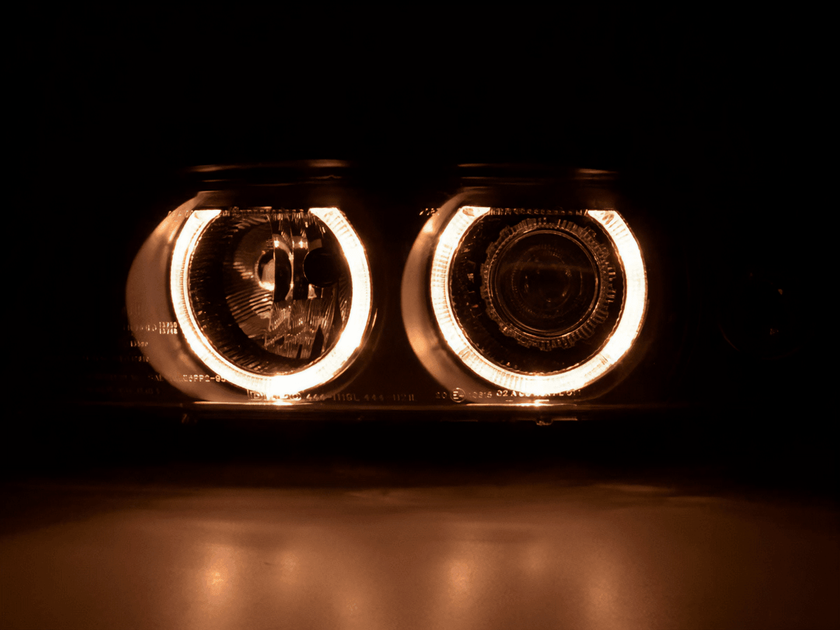 BMW E39 5-Series headlights with Xenon angel eye rings by K2 Industries, showing the front view with illuminated rings.