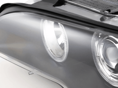 BMW E46 3-Series Coupe black OE+ Angel Eyes headlights by K2 Industries, showing the headlights with black housing and angel eye rings.