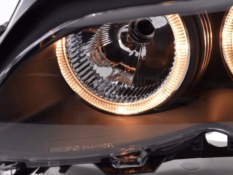 BMW E46 3-Series sedan black OE+ Angel Eyes headlights by K2 Industries, showing the sleek headlights with angel eye rings.