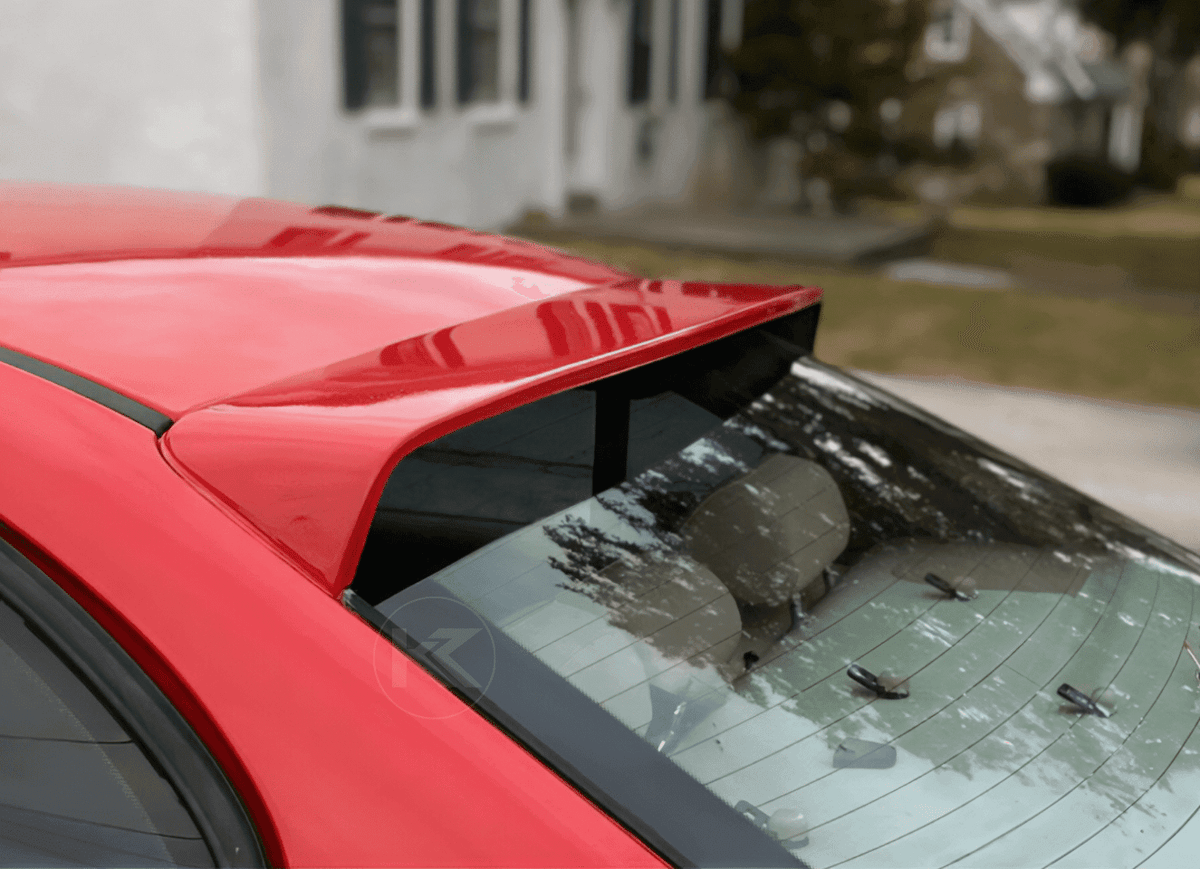 Black BMW E46 Sedan Series 3 roof spoiler by K2 Industries, mounted on the car's rear roof for aerodynamic style.