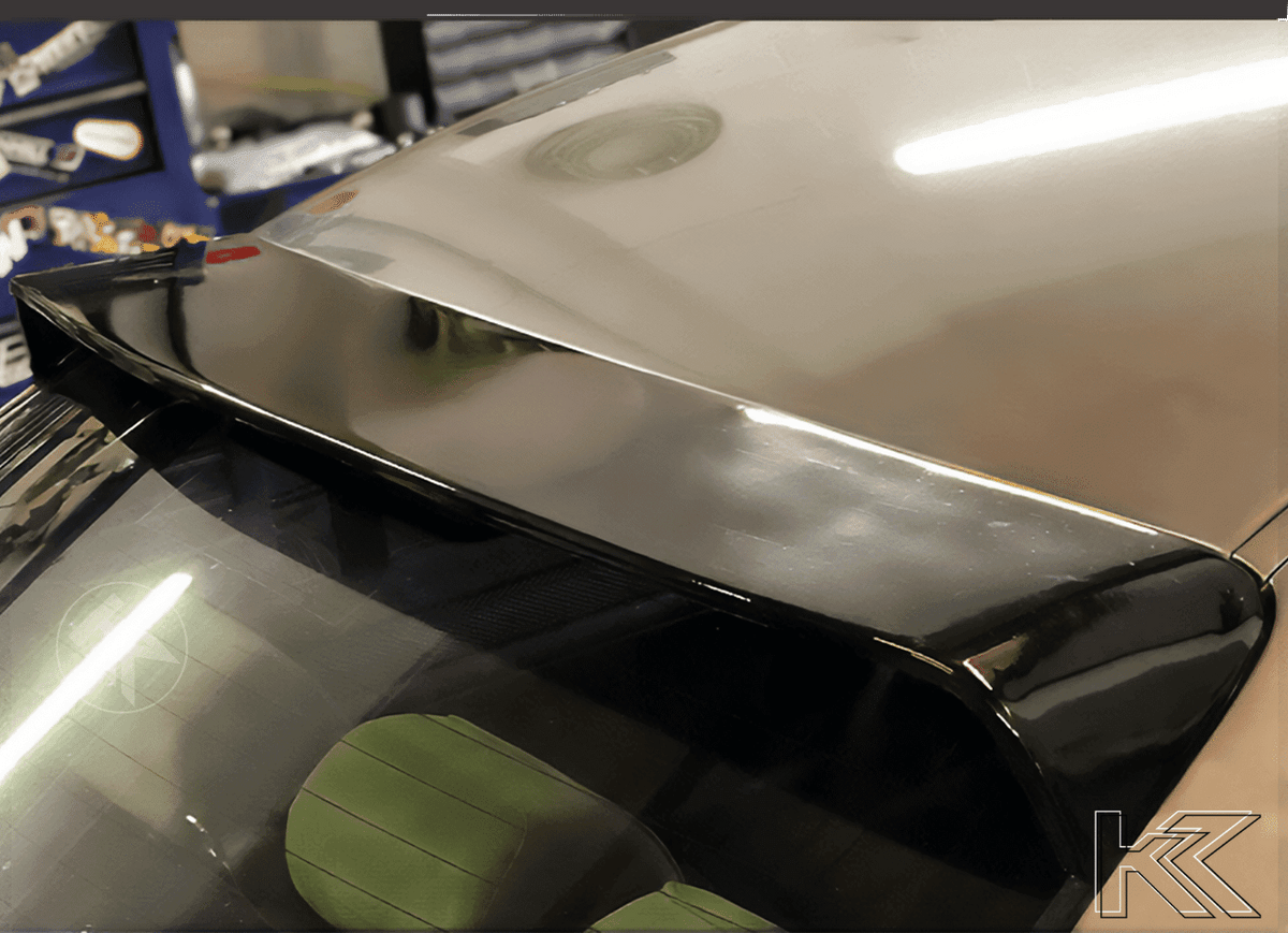 Black K2 Industries roof spoiler for BMW E46 Sedan Series 3, enhances aerodynamics and style on 1998-2006 models.