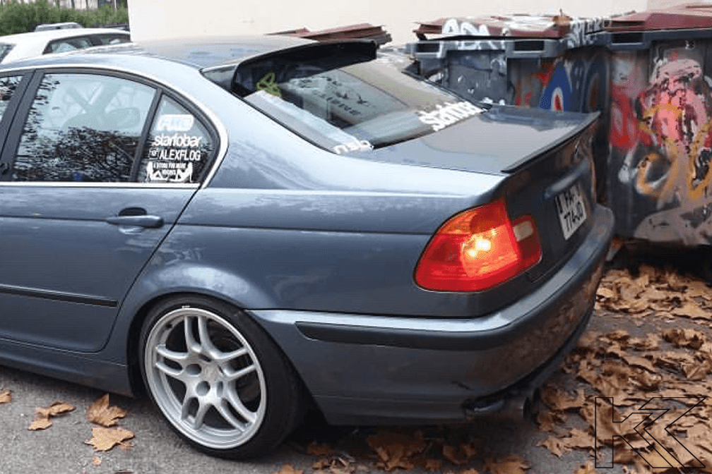 Black BMW E46 Sedan Series 3 roof wing spoiler by K2 Industries, designed for model years 1998 to 2006, mounted on the car roof.