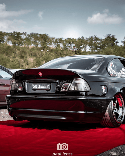 BMW E46 coupe clear smoked LED tail lights by K2 Industries, showing sleek design and LED illumination on the vehicle.